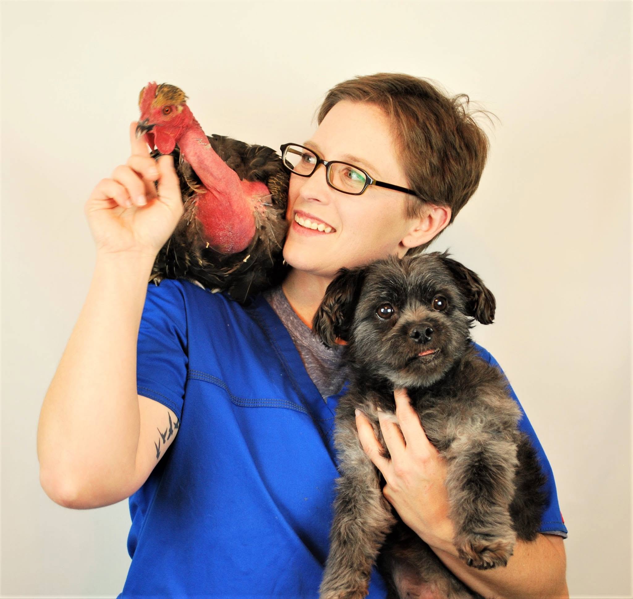 Lindsie Parks holding a dog and a rescued chicken
